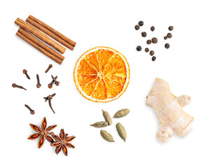 Top view of set or collection of seasonal mulling spices mixture consists of dry cinnamon sticks, orange slice, cloves, anise star, cardamom, fresh ginger and black pepper isolated on white background