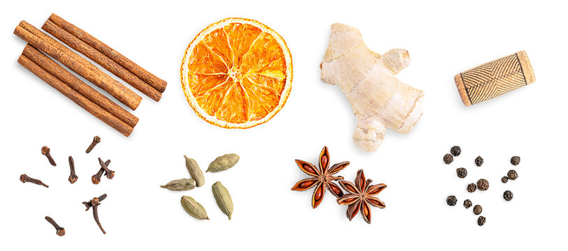 Top view of group or collection of mulled wine spices mixture consists of cinnamon sticks, orange citrus slice, cloves, anise star, cardamom, fresh ginger, cork and black pepper isolated on white