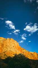 Rocky cliffs under blue sky in Noravank Canyon, Armenia by the setting sun