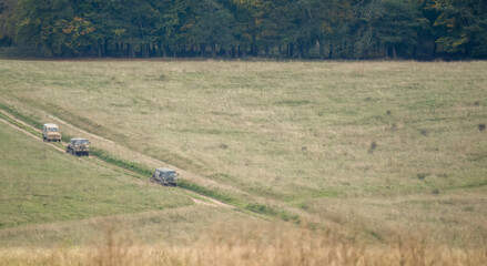 a pair of British army bae systems, Puch, Daimler, Pinzgauer High-Mobility All-Terrain 6x6 vehicles towing a 105mm Light Artillery Guns on a military exercise © Martin