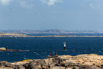 scissor islands off sm&ouml;gen in sweden, with bright sunshine and small white clouds