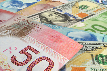 Canadian dollar and US dollar banknotes. Cash. Financial concept.