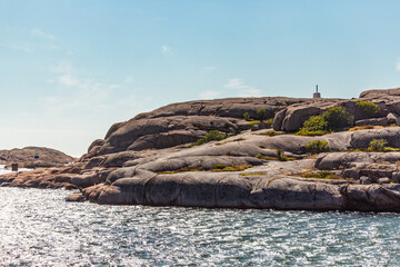 scissor islands off sm&ouml;gen in sweden, with bright sunshine and small white clouds