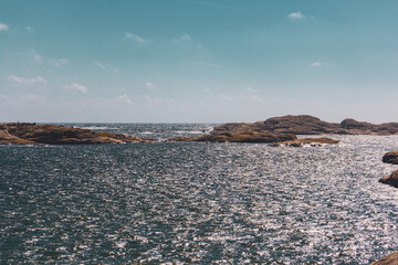 scissor islands off sm&ouml;gen in sweden, with bright sunshine and small white clouds