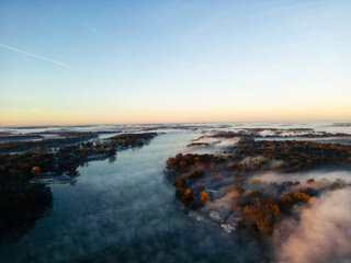 sunrise over the river with morning fog golden hour