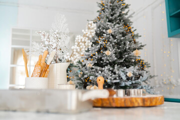 Cozy kitchen with Christmas tree and festive decorations during winter season