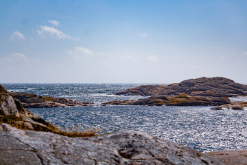 scissor islands off smögen in sweden, with bright sunshine and small white clouds
