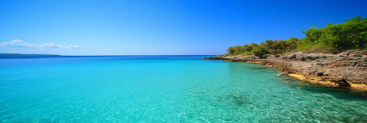 Beautiful beach with lush greenery and with turquoise sea and rocks against blue sky with clouds on sunny summer day. Landscape background for relaxing vacation on island.