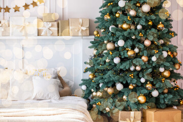A beautifully decorated Christmas tree next to a cozy bedroom in winter