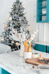 Festive kitchen setting with decorated Christmas tree and holiday decorations