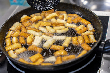 The dough is fried in pieces in a pan in oil (Pa Thong Ko), Baursaks or chak chak is a traditional national dish.