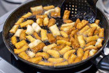 The dough is fried in pieces in a pan in oil (Pa Thong Ko), Baursaks or chak chak is a traditional national dish.