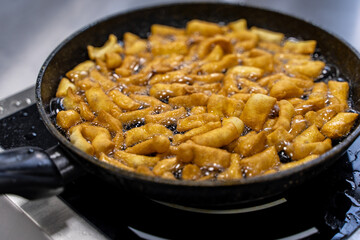 The dough is fried in pieces in a pan in oil (Pa Thong Ko), Baursaks or chak chak is a traditional national dish.