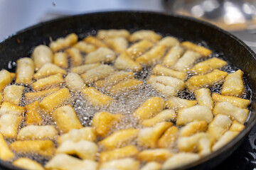 The dough is fried in pieces in a pan in oil (Pa Thong Ko), Baursaks or chak chak is a traditional national dish.