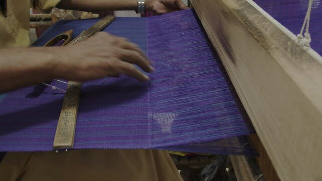 Traditional weaving technique in an old and colourful weaving shop