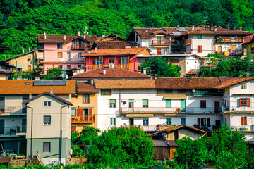 Discover the charm of a quaint Italian village with vibrant houses amidst natures beauty