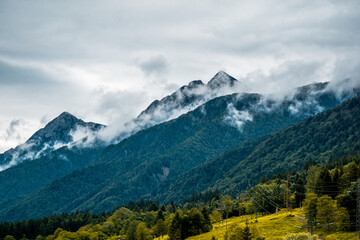Majestic and breathtaking mountain range looms gracefully under vast, cloudy skies that inspire awe