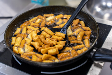 The dough is fried in pieces in a pan in oil (Pa Thong Ko), Baursaks or chak chak is a traditional national dish.