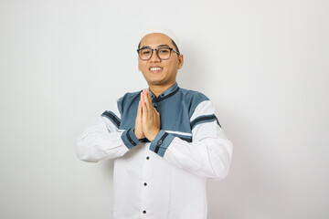 Moslem Asian man smiling to give greeting during Ramadan celebration