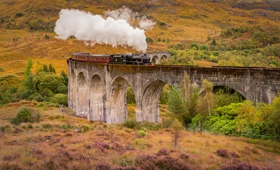 Steam train at Glenfinnan Autumn in Scotland with reflections in the lochs