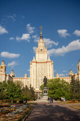 MOSCOW, RUSSIA - 30 SEPTEMBER 2023: View of the Lomonosov Moscow State University building through the park's trees on an summer day.