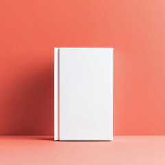 a mockup with a blank white book cover against a peach colored background