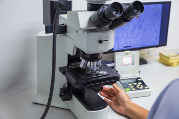 Experts inspect steel structures for microdamage using a microscope.