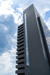Tall skyscraper in Prague, cloudy sky on background