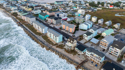 Aerial view of coastal residential properties vulnerable to climate change effects, facing rising insurance costs and increased risk from hurricanes and natural disasters.