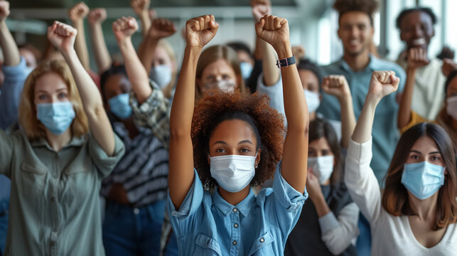 Unity in diversity: group of people wearing masks and raising fists in solidarity