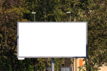 Background for design, white billboards on city streets and along roads in the summer day