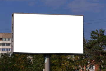 Background for design, white billboards on city streets and along roads in the summer day