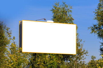 Background for design, white billboards on city streets and along roads in the summer day