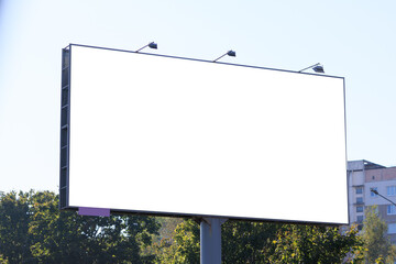 Background for design, white billboards on city streets and along roads in the summer day