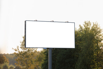 Background for design, white billboards on city streets and along roads in the summer day