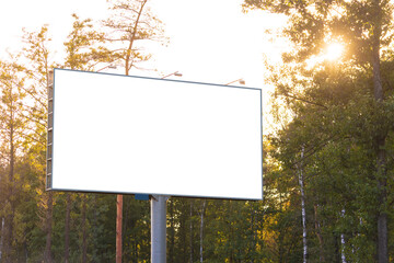 Background for design. Advertising billboard along the road in the city on a autumn sunny evening