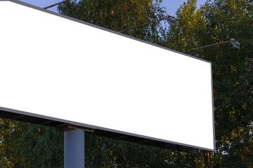 Background for design, white billboards on city streets and along roads in the summer day