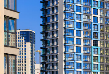 Fototapeta premium City view, modern buildings and skyscrapers against the blue sky.