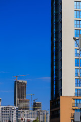 Naklejka premium Modern buildings, walls and windows. City view on a sunny day. 
