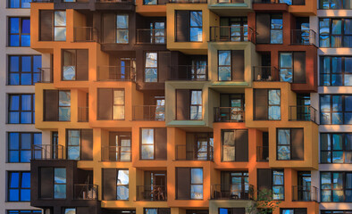 Fototapeta premium Texture of modern buildings, background for design. Elements of architectural decorations of buildings, modern windows, walls and balconies.