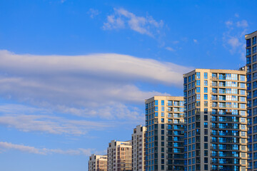 City view, modern buildings and skyscrapers against the blue sky.