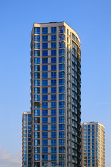 City view, modern buildings and skyscrapers against the blue sky.