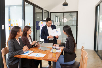 A group of Asian businessmen is Meeting to discuss presentations exchange knowledge Presentation about office work