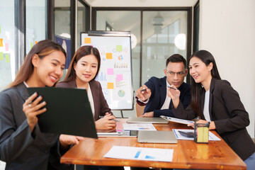 Group of Asian businessmen are sitting in a meeting, talking, exchanging knowledge. Presentation about office work