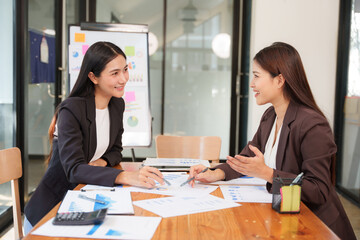 Asian Business Group Chat about graph work Present in meetings, in the office