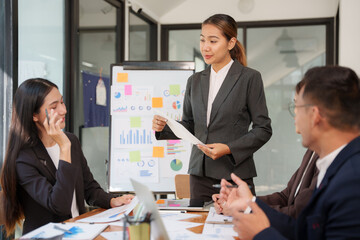 Group of Asian businessmen are sitting in a meeting, talking, exchanging knowledge. Presentation about office work