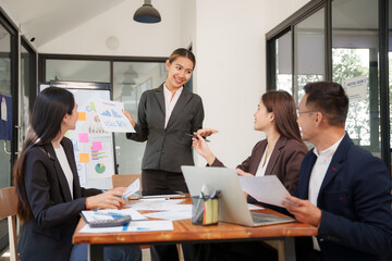 A group of Asian businessmen is Meeting to discuss presentations exchange knowledge Presentation about office work