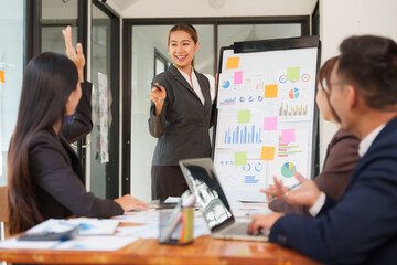 A group of Asian businessmen is Meeting to discuss presentations exchange knowledge Presentation about office work