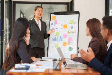 Group of Asian businessmen are sitting in a meeting, talking, exchanging knowledge. Presentation about office work