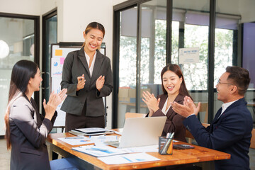 A group of Asian businessmen is Meeting to discuss presentations exchange knowledge Presentation about office work